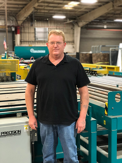 Man standing in custom sheet metal facility